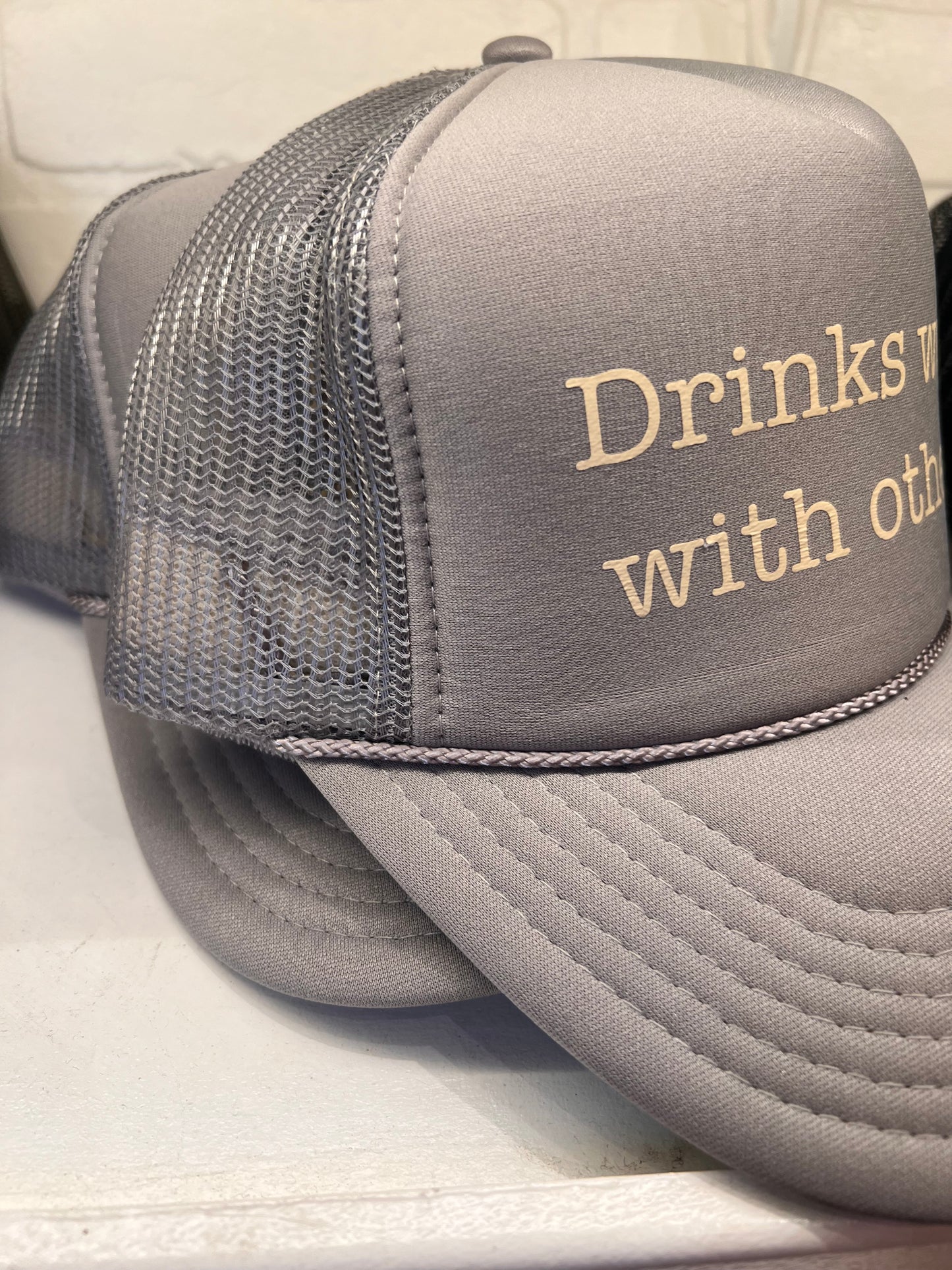 Drinks well with others Trucker Hat